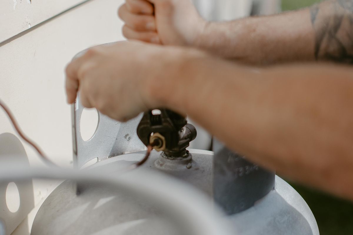 Plumber working on a gas bottle regulator