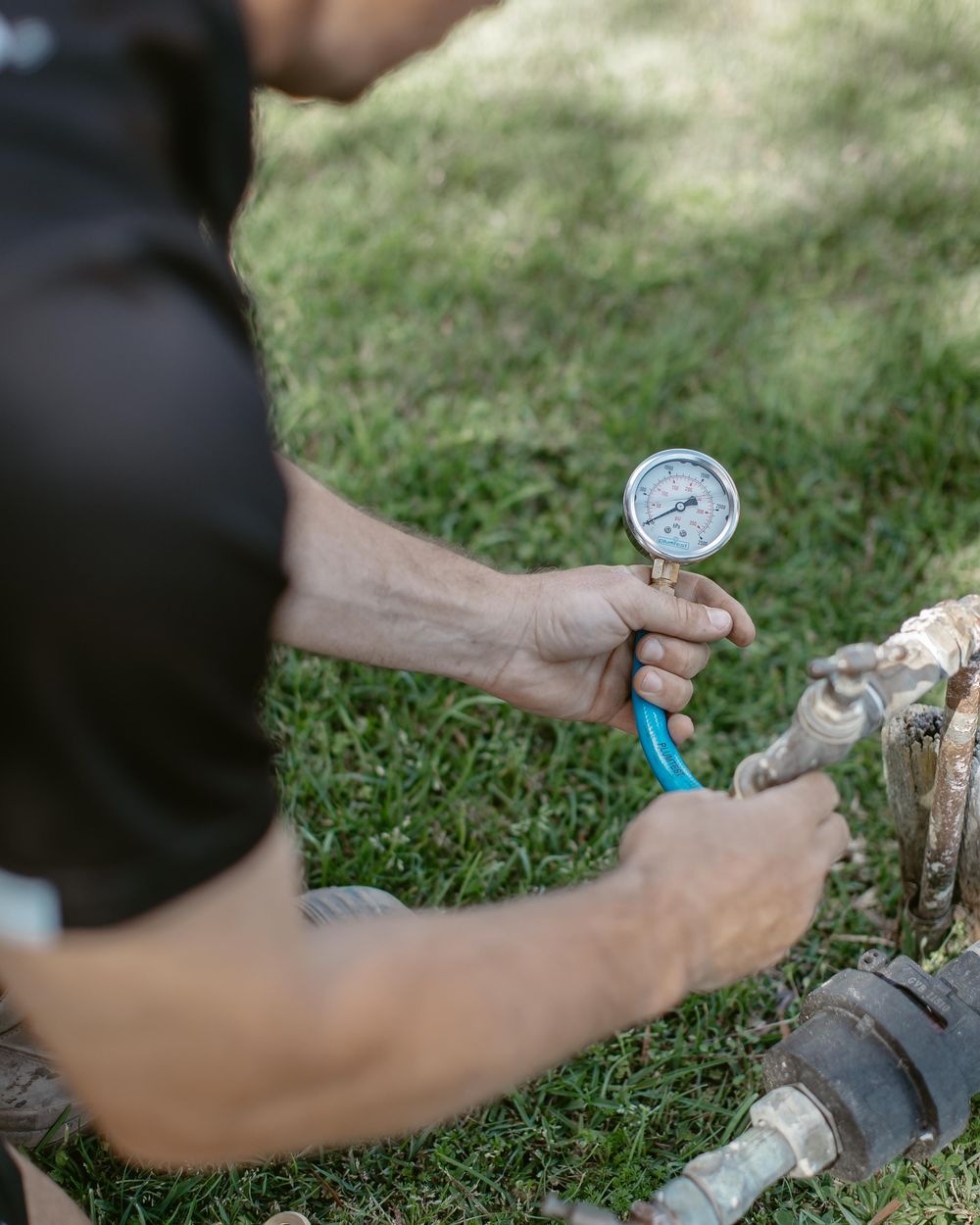 Plumber pressure testing a water service